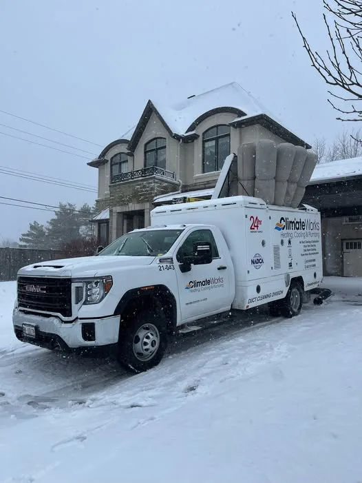 Climate Works duct cleaning truck on a snowy Ottawa driveway during a service call